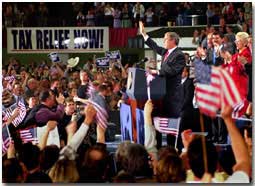President George W. Bush waves goodbye to a crowd of over 8,000 supporters at the end of his event at the MetraPark Expo and Convention Center in Billings, Montana, Monday, March 26, 2001.