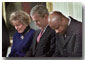 President George W. Bush lowers his head in prayer between Shirley Dobson, left, and Rev Wintley Phipps during a reading of "Our Nations Prayer" at the White House reception for the 50th Anniversary of the National Day of Prayer. WHITE HOUSE PHOTO BY ERIC DRAPER
