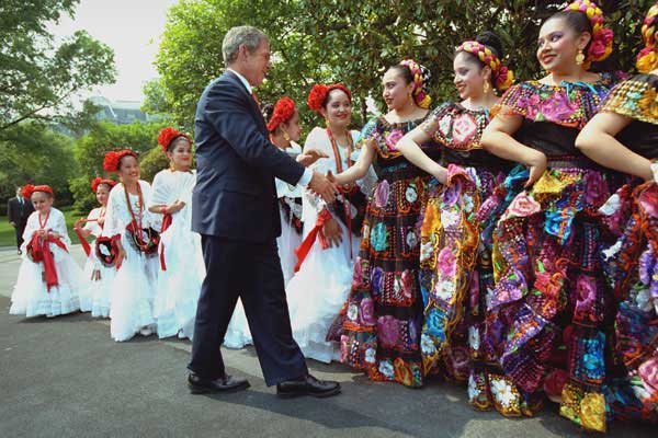 President George W. Bush greets dancers before their performance during Cinco De Mayo festivities at the White House Friday, May 4. WHITE HOUSE PHOTO BY ERIC DRAPER