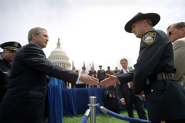 President George W. Bush greets a police officer from Flagstaff, AZ., after placing a wreath to commemorate the 20th Annual Peace Officers' Memorial Service at the Capitol. WHITE HOUSE PHOTO BY ERIC DRAPER