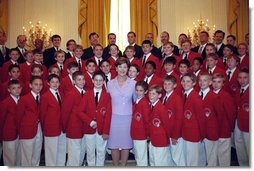 Laura Bush poses with the Philadelphia Boys Choir following their performance at the Senate Spouses Luncheon in the East Room June 4, 2001.  White House photo by Susan Sterner