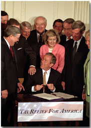 President George W. Bush signs the tax bill on Thursday, June 7 in the White House.