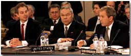 President George W. Bush speaks with Secretary of State Colin Powell, center and British Prime Minister Tony Blair at the Secretary General's office at NATO headquarters in Brussels, Belgium on June 13, 2001. WHITE HOUSE PHOTO BY PAUL MORSE
