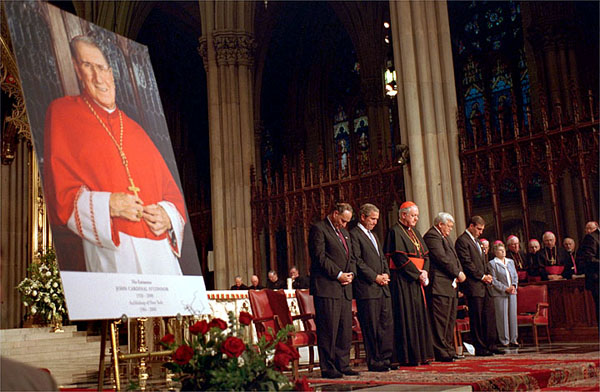 President Bush and church leaders bow their heads in prayer during congressional gold medal ceremony in honor of Cardinal O'Connor Tuesday, July 10, 2001. White House photo by Eric Draper.