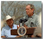 President Bush speaks to the media and local farmers during a signing for a farm relief bill at his ranch in Crawford, Aug. 13, 2001. White House photo by Moreen Ishikawa.