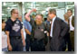 Showing off a little motor muscle, employees at Harley Davidson took turns showing President Bush around their Milwaukee factory during a visit Aug. 20. White House photo by Moreen Ishikawa.