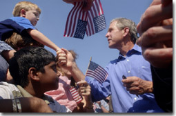 President George W. Bush greets the families of Michigan Teamster Union members during a Labor Day Barbecue at Teamsters Headquarters in Detroit, Michigan, Sept. 3, 2001. WHITE HOUSE PHOTO BY ERIC DRAPER.