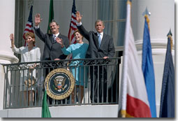 Waving from the White House balcony, President Bush welcomes Mexican President Vicente Fox during the President's First State Visit Sept. 6. White House Photo by David Bohrer.