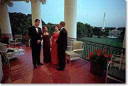 Mexican President Vicente Fox and his wife Martha Sahagun de Fox talk privately with President Bush and First Lady Laura Bush on the Truman Balcony of the White House before greeting guests at the state dinner Wednesday evening. After the dinner, the two couples and their friends watched fireworks from the balcony. White House photo by Eric Draper.