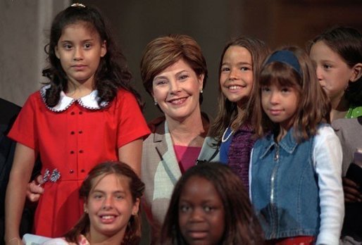 Laura Bush poses with children participating the National Book Festival Back to School event in the Great Hall at the Library of Congress Jefferson Building Sept. 7, 2001 in Washington, D.C. White House photo by Moreen Ishikawa.