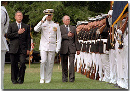 With their hands over their hearts, President Bush and Australian Prime Minister John Howard perform a military pass and review at the Washington Navy Yard Sept. 10, 2001. Commemorating 50 years of military alliance, the President and Prime Minister spoke to assembled military personnel, shared lunch and spoke privately in the Oval Office. White House photo by Tina Hager.