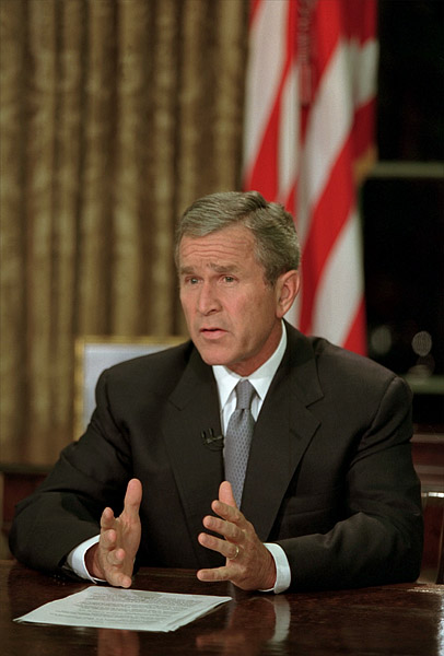 President George W. Bush addresses the nation from the Oval Office after attacks on the World Trade Center and the Pentagon Sept. 11, 2001. "This is a day when all Americans from every walk of life unite in our resolve for justice and peace," said the President. "America has stood down enemies before, and we will do so this time.". White House photo by Paul Morse.