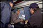 President George W. Bush tours the World Trade Center disaster site aboard Marine One with New York Mayor Rudolph Giuliani, left, and New York Governor George Pataki, Friday, Sept. 14, 2001. White House photo by Eric Draper