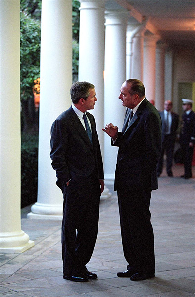 Walking along the West Wing Colonnade, President Bush and French President Jacque Chirac discuss current matters Sept. 18. White House photo by Paul Morse.
