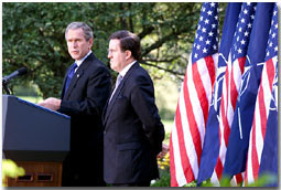 President Bush and NATO Secretary General Lord Robertson address the media in the Rose Garden Oct. 10. "(NATO's support after the attacks) was an act of great friendship in a time of great need, and our country will never forget.," said the President in his remarks. White House photo by Paul Morse.