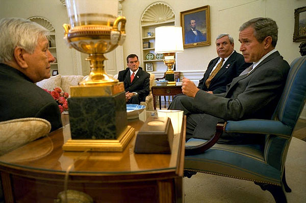 President George W. Bush meets with Director of the Office of Homeland Security Tom Ridge, Postmaster General John Potter, and President of the National Association of Letter Carriers Vince Sombratto in the Oval Office Oct. 22. White House photo by Tina Hager.