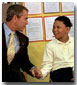 President George W. Bush talks with a student at Thurgood Marshall Extended Elementary School, where he announced his initiative, Friendship Through Education, Oct. 25. 
