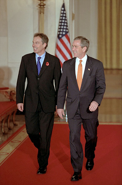 President George W. Bush and Prime Minister Tony Blair of England walk out to address the media in Cross Hall at the White House Nov. 7. "We've got no better friend in the world than Great Britain," said the President during his remarks. White House photo by Paul Morse.