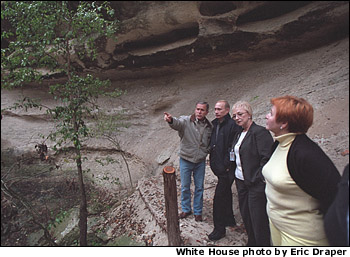 President George W. Bush and Russian President Vladimir Putin tour a canyon and waterfall at the Bush Ranch in Crawford, Texas, Wednesday, Nov. 14, 2001. Also pictured are Russian First Lady Lyudmila Putin, far right, and interpreter Irene Firsow. White House photo by Eric Draper.