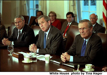 With Secretary of State Colin Powell and Secretary of Defense Donald Rumsfeld sitting at his side, President <a href="/news/releases/2001/11/20011119-12.html">George W. Bush</a> speaks with the media during a cabinet meeting Nov. 19. White House photo by Tina Hager.