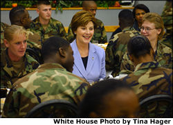 Laura Bush talks with members of the 101st Airborne at Fort Campbell, Kentucky. Known as "The Screaming Eagles," this airborne division took part in the largest airborne assault of World War II and also served in Vietnam and more recently in the Balkans. White House photo by Tina Hager.