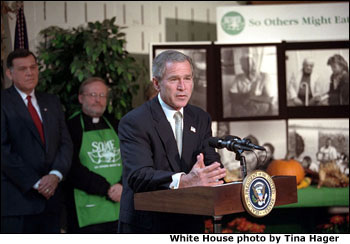 Urging Americans to give of themselves during this holiday season, President <a href="/news/releases/2001/11/20011120-5.html">George W. Bush</a> addresses volunteers and media at So Other Might Eat interfaith charity in Washington, D. C., Nov. 20. Preparing breakfast and lunch, the programs serves more than 300,00 meals to homeless each year. White House photo by Tina Hager.