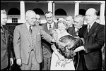 Photograph of President Truman receiving a Thanksgiving turkey from members of the Poultry and Egg National Board and other representatives of the turkey industry, outside the White House.