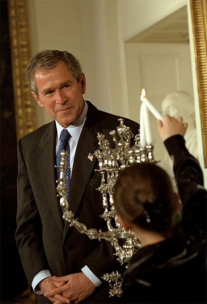 "Tonight, for the first time in American history, the Hanukkah menorah will be lit at the White House residence," said President George W. Bush at the ceremony in which 8-year-old Talia Lefkowitz helps lit the menorah Dec. 10. White House photo by Eric Draper.