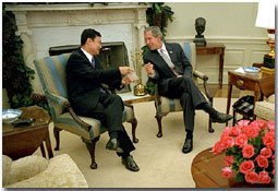 President George W. Bush meets with Prime Minister Thaksin Shinawatra of Thailand in the Oval Office Dec. 14, 2001. The two leaders discusses economic issues and the war on terrorism. White House photo by Eric Draper.