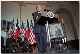 As Mrs. Bush and Texas Governor Rick Perry listen, President George W. Bush speaks during the ceremony for the unveiling of his portrait painted by Scott Gentling at the Texas State Capitol in Austin Jan. 4, 2001. White House photo by Eric Draper.