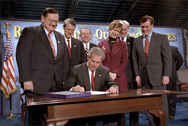 President George W. Bush signs the Small Business Liability Relief and Brownfields Revitalization Act in Conshohocken, Pennsylvania, Jan. 11. Standing left to right and Rep. Paul Gillmor of Ohio, Rep. Robert Borski of Penn., State Attorney General Mike Fisher, EPA Administrator Christie Todd Whitman, Rep. Joseph Hoeffel of Penn. and Pennsylvania Governor Mark Schweiker. White House photo by Eric Draper.