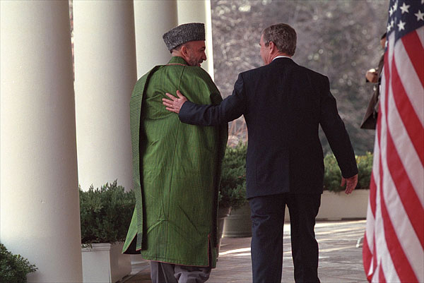 President George W. Bush and Chairman Karzai walk along the colonnade in the Rose Garden after their joint press conference Jan. 28. "The United States is committed to building a lasting partnership with Afghanistan," said the President. "We'll help the new Afghan government provide the security that is the foundation for peace." White House photo by Tina Hager.