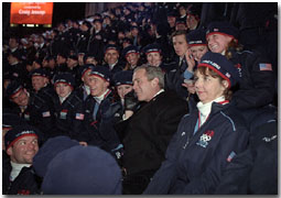 Taking a phone call from an athlete's family, President George W. Bush sits with America's Olympic athletes during the opening ceremonies for the 2002 Winter Olympic Games in Salt Lake City, Utah, Feb. 8. White House photo by Paul Morse.