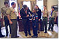 President George W. Bush talks with Jordon Wade, 9, of Pittsburgh during the presentation of the annual report by the Boy Scouts of America in the Oval Office Feb. 12, 2002. Other scouts included in the ceremony are, from left to right, Joe Honious, 16, of Dayton, Ohio; Clay Capp, 18, of Nashville, Tenn.; national Venturing President Marissa Morgan, 19, of Winston-Salem, NC; Joshua Cudd, 12, of Conroe, Texas; and Ryan Iwata, 12, of San Francisco. Not pictured is David Richey, 18, of Seattle, Wash. White House photo Eric Draper.