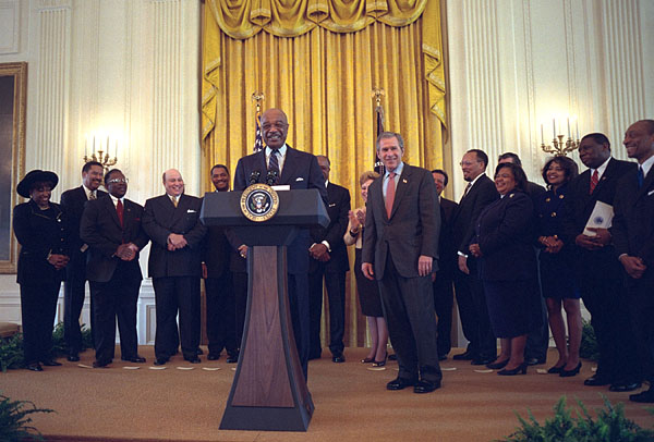 President George W. Bush listens as Secretary of Education Rod Paige speaks to visiting leaders from historically black colleges in the East Room, Feb. 12, 2002. Pledging to help historically black colleges, President Bush has created a presidential advisory board that will report on the schools' academic performances, uses of technology, and development. White House photo by Eric Draper.