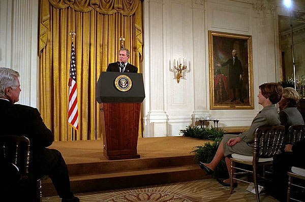 President George W. Bush addresses the White House Conference on Preparing Tomorrow's Teachers in the East Room March 4, 2002. Pictured in the audience from left to right is U. S. Sen. Edward Kennedy (D-Mass.), Laura Bush and Lynne Cheney. "We're focusing much of the teacher training effort on specific needs, like special education or math or science, and one of my passions, early reading," said the President. "The Reading First program is aimed at making sure every child of every background can read by the third grade." White House photo by Eric Draper.