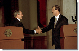 President George W. Bush reaches for Mexico's President Vicente Fox during a joint press conference at the Palacio de Gobierno in Monterey, Mexico, Friday, March 22. 