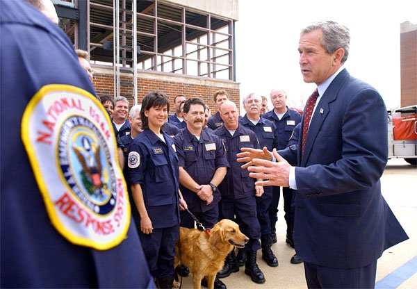 President George W. Bush speaks with members of Texas Task Force 1 Urban Search and Rescue Team, who assisted at Ground Zero, following a photo opportunity at the Dallas Fire Department's Maintenance and Training Facility in Dallas, Texas, Thursday, March 28. White House photo by Eric Draper.