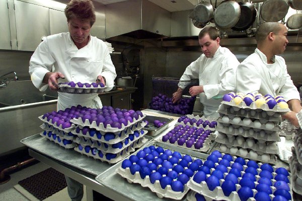White House chefs arrange some of the thousands of dyed eggs in preparation for the annual Easter Egg Roll on the South Lawn of the White House on April 1, 2002. White House Photo by Paul Morse.