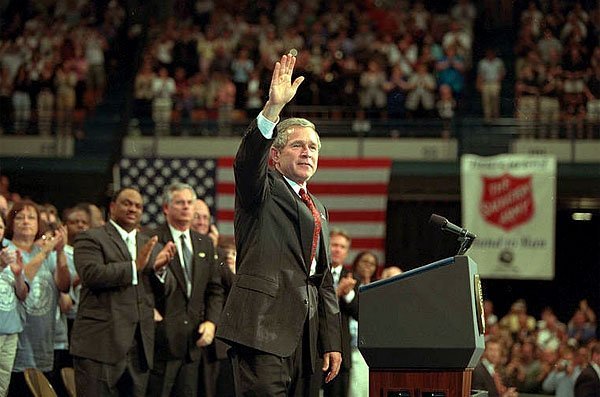  President George W. Bush waves during his visit to the Knoxville Civic Center in Knoxville, Tenn., Monday, April 8. Listing several specific ways Americans can volunteer, the president spoke about the value and need of community service. To learn more, call 1-877-USA-CORPS or <a href="/infocus/citizencorps/" width=