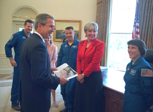 President George W. Bush meets with the crew of the Columbia Space Shuttle in the Oval Office Wednesday, April 17, 2002. Completing a mission to service the Hubble Space Telescope in March, the crew shared stories and photographs with President Bush. Pictured with the President, from left to right, are Commander Scott Altman and his wife Jill Altman; Pilot Duane "Digger" Carey and his wife Cheryl Carey; and Mission Specialist Nancy Currie. WHITE HOUSE PHOTO BY PAUL MORSE.