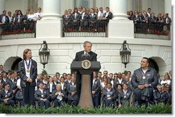President George W. Bush addresses visiting athletes during a ceremony honoring the efforts of the U.S. Olympic and Paralympic teams on the South Lawn Tuesday, April 23. Pictured on stage with the President is gold medalists Tristan Gale, left, and Manuel Guerra. "It is a great honor to host our nation's Olympic and Paralympic athletes here at the White House," said the President "You competed with honor, you won with humility and you made America proud." White House photo by Tina Hager.