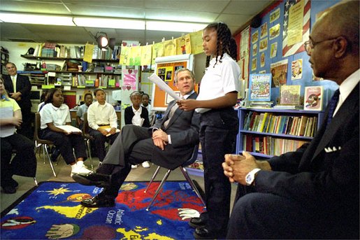 President George W. Bush listens to students read about American values during a visit to Vandenberg Elementary School in Southfield, Mich., Monday, May 6. White House photo by Tina Hager.