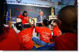 President George W. Bush visits with teacher Carolyn Davis and her students at Clarke Street Elementary School in Milwaukee, Wis., Wednesday, May 8. "I'm here because this is a great school that believes every child can learn," said President Bush who listened to the students demonstrate their reading drills. During his talk with the children, the President emphasized the importance of reading over watching television. White House photo by Tina Hager.