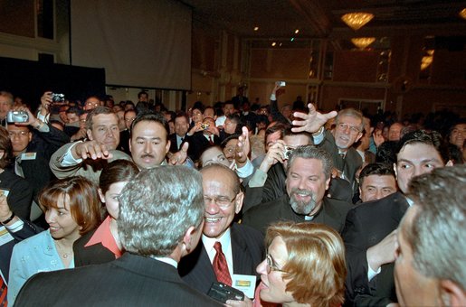 President George W. Bush wades into an enthusiastic crowd after speaking at the Hispanic National Prayer Breakfast in Washington, D.C., May 16, 2002. White House photo by Paul Morse.