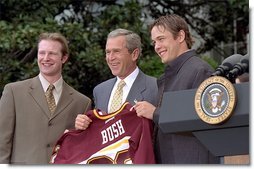 President George W. Bush accepts a team jersey from the NCAA Championship hockey team from the University of Minnesota on the South Lawn Tuesday, May 21. Also attending were University of Connecticut's women's basketball team, University of Maryland's men's basketball team, and University of Minnesota's women's hockey team. White House photo by Tina Hager.