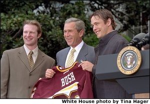 President George W. Bush accepts a team jersey from the NCAA Championship hockey team from the University of Minnesota on the South Lawn Tuesday, May 21. Also attending were University of Connecticut's women's basketball team, University of Maryland's men's basketball team, and University of Minnesota's women's hockey team. White House photo by Tina Hager.