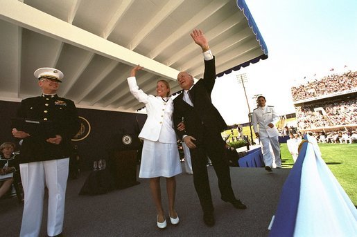 After speaking at the United States Naval Academy commencement, Vice President Dick Cheney waves with a graduate to her family in the stadium May 24, 2002. White House photo by David Bohrer