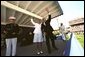 After speaking at the United States Naval Academy commencement, Vice President Dick Cheney waves with a graduate to her family in the stadium May 24, 2002. White House photo by David Bohrer