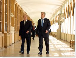 President George W. Bush walks through the halls of St. Petersburg State University with President Vladimir Putin before a question and answer session with students in St. Petersburg, Russian on May 25, 2002. White House photo by Paul Morse.